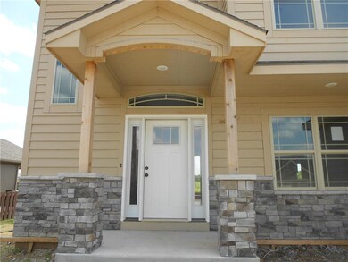 Front door has a covered entry.  Stone trim
