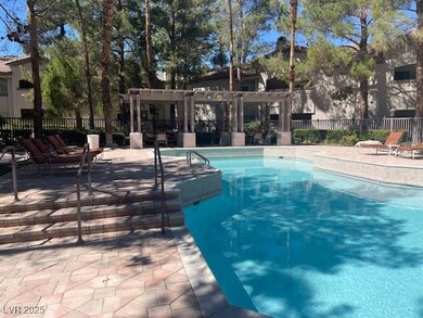Community pool featuring a patio and a pergola