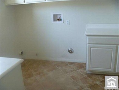 Large laundry room just off kitchen with cabinets 