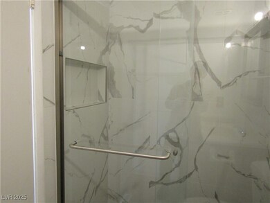 Full bath featuring a marble finish shower