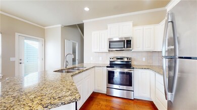 Kitchen with granite and stainless steel appliances.
