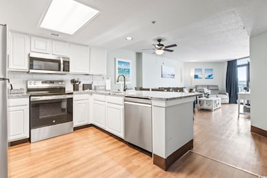 Kitchen featuring a peninsula, light wood finished