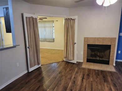 Unfurnished living room featuring a tile fireplace