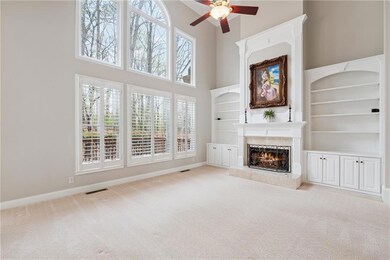 2 story window wall and built in bookshelves surro