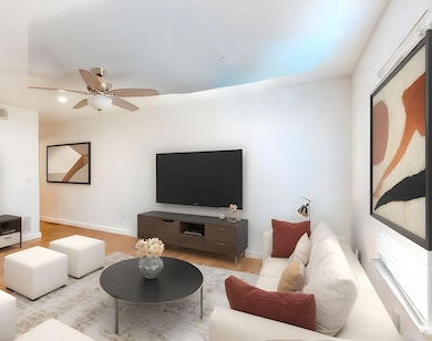 Living area featuring ceiling fan, wood finished 