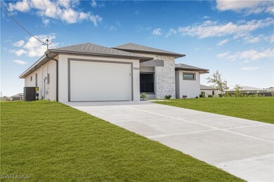 Prairie-style house featuring a garage, central AC
