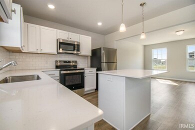 White cabinetry is accented by light color quartz 