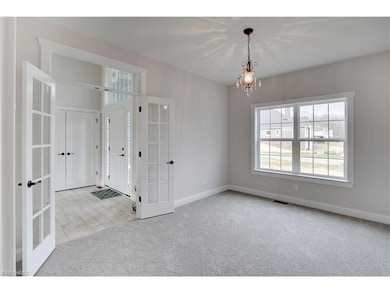 French doors leading from foyer into office with c