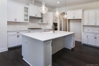 Lovely kitchen layout with Gas Cooktop and wall mo