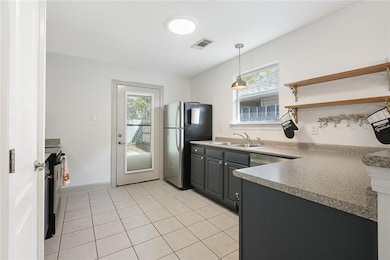 KITCHEN WITH AMPLE CABINETS AND A PANTRY