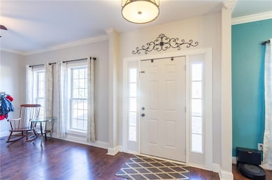 Foyer entrance with dark wood-type flooring, baseb