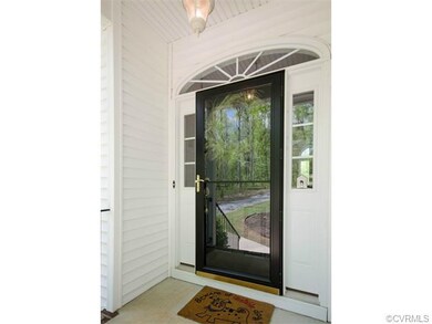 The covered front porch is welcoming and complete with a storm door, sidelight windows and a Palladian arch.