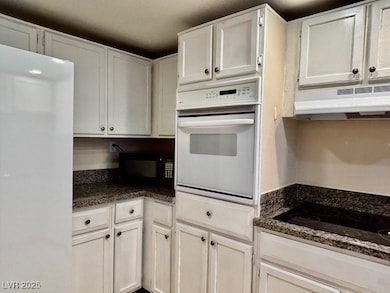 Kitchen with under cabinet range hood, black appli
