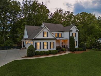 View of front of home featuring driveway, roof wit
