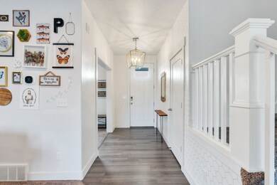Entrance foyer with a chandelier and wood finished floors