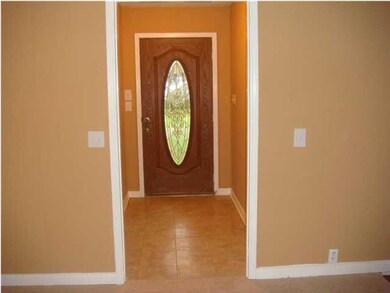 The foyer has a beautiful door & ceramic tile floo