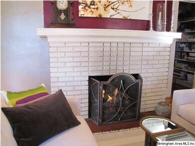 Living room fireplace with gas logs.