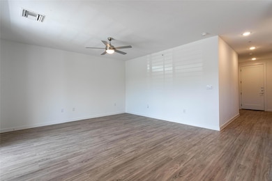 Spare room featuring wood finished floors, ceilin