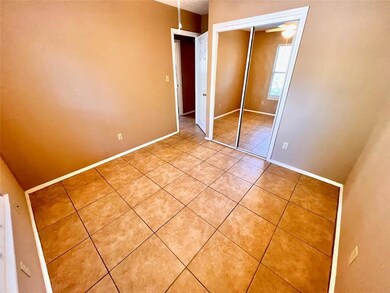 Unfurnished bedroom featuring light tile patterne