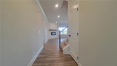 Hall with ornamental molding and wood-type floorin