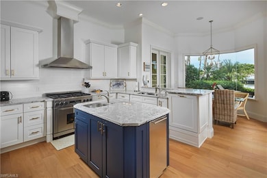 Kitchen featuring white cabinetry, high end range,