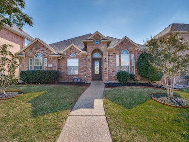 View of front of property featuring pretty drive up appeal with solid iron front door, brick siding, and new composition shingled roof