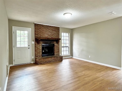 Den with New Flooring, Paint and Light Fixture