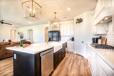 Kitchen featuring tasteful backsplash, stainless s