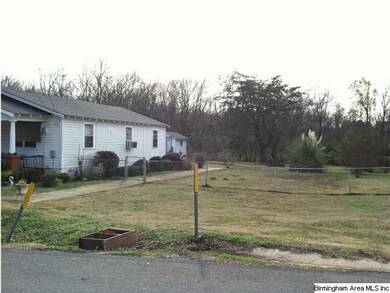 Side of house and vacant lot.