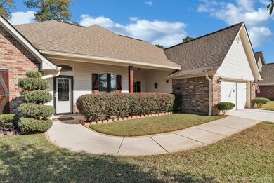 View of front facade featuring a porch, a garage, 