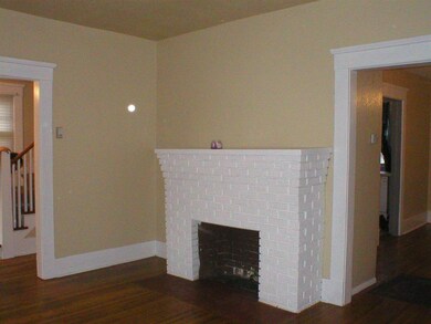 Living room with decorative fireplace & hardwood f