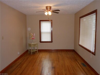 Living room with wood floors, natural wood trim on