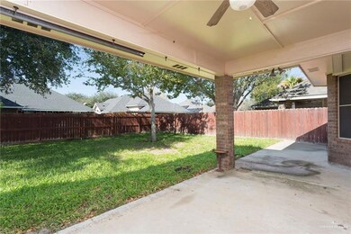 Fenced backyard featuring a patio and ceiling fan