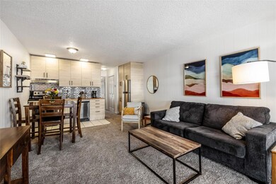 Living room with carpet and a textured ceiling