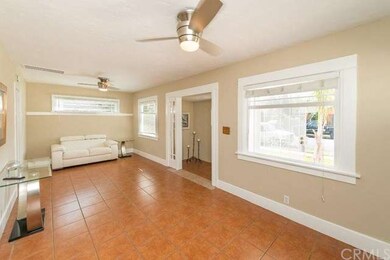 Living room with two ceiling fans and natural ligh