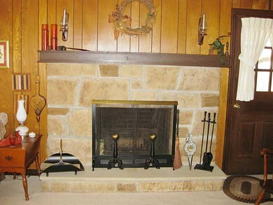 Family Room. Stone gas log fireplace makes the fam