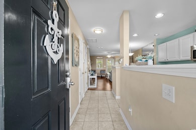 Corridor featuring light tile patterned floors