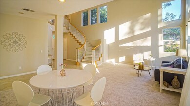 Formal dining, tall vaulted ceilings throughout, new carpeting downstairs.