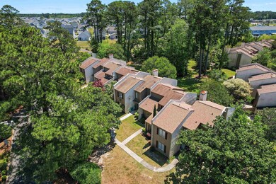 Aerial view of property's location with nearby suburban area