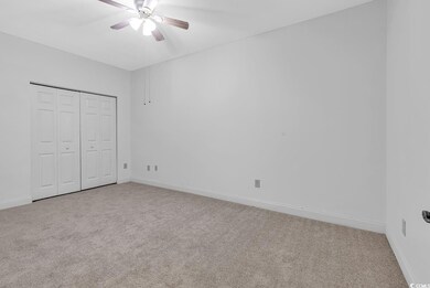 Unfurnished bedroom with light colored carpet, a c