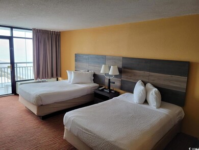 Carpeted bedroom with a textured ceiling and acces