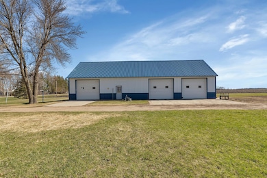 All three overhead garage doors in shed are insulated plus there are two walk through service doors and a sliding door on the west side.
