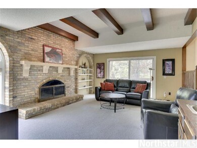 Timber beams and a large wood burning fireplace an
