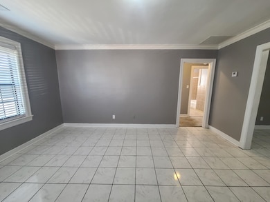 Empty room with baseboards and ornamental molding