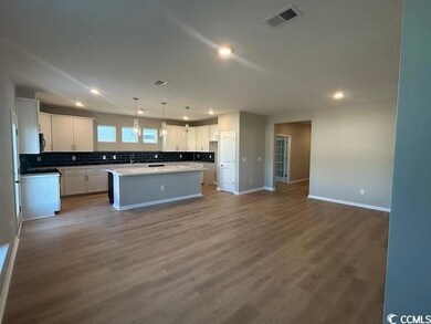 Kitchen with white cabinets, decorative backsplash