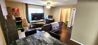 Living room featuring ceiling fan, a textured ceil