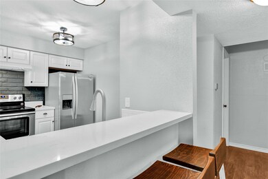 Kitchen opens up to living/office.