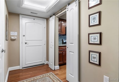 Foyer with barn door, open to kitchen