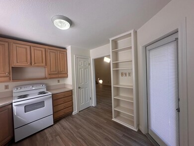 Kitchen featuring dark wood-style flooring, elect