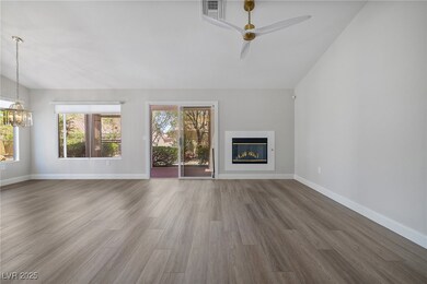 Unfurnished living room featuring a ceiling fan, a